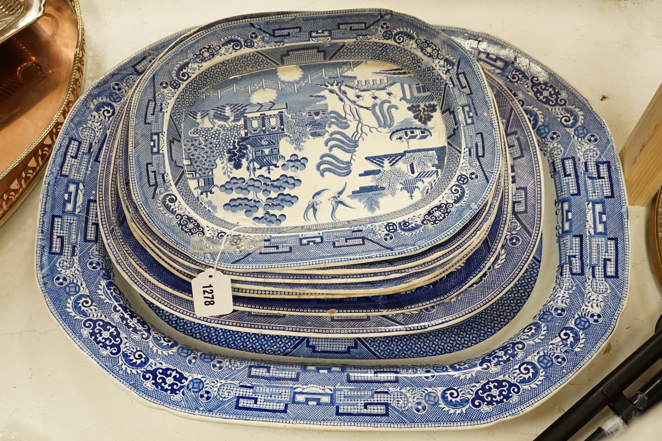 A 19th century transfer-printed large blue and white platter and seven similar smaller platters (8), largest 62cms wide